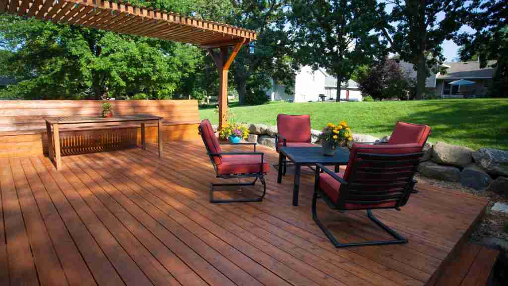 Modern backyard deck showcasing popular home remodeling trends with outdoor seating and a wooden pergola