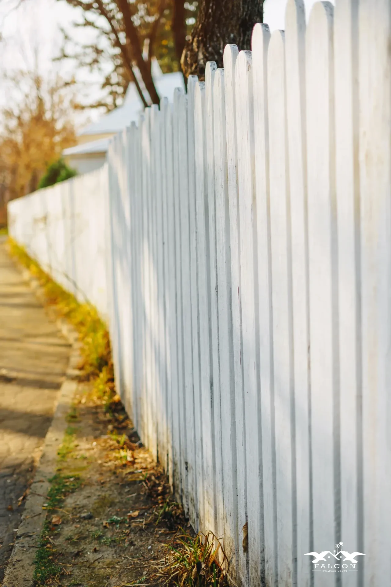 Fence installation service showcasing freshly installed white picket fence providing privacy and classic curb appeal for residential property.