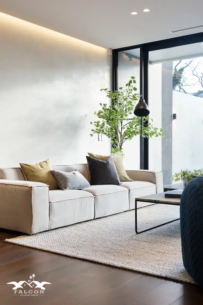 Home remodeling in San Diego featuring a modern full-service home remodeling project with a bright, minimalist living room, large windows, neutral furnishings, and upgraded finishes—ideal for whole house remodel in San Diego and full home remodeling designs