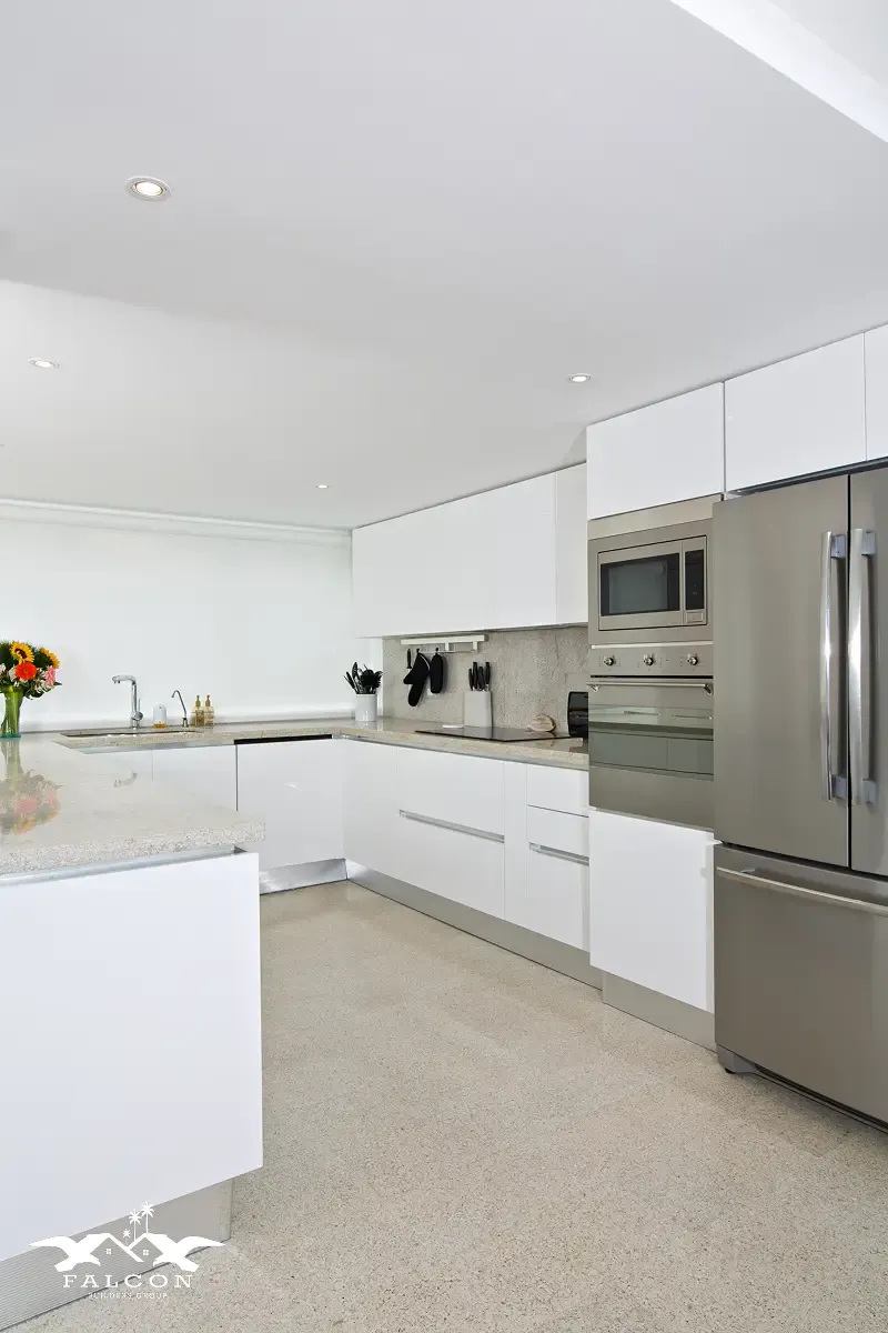 Kitchen remodeling in San Diego featuring a bright modern kitchen with sleek white cabinets, stainless steel appliances, quartz countertops, and a clean minimalist layout—ideal for full home remodeling in San Diego and whole house remodel upgrades.