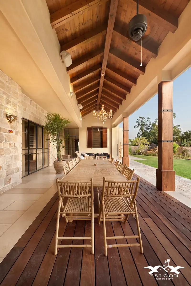 Outdoor remodeling in San Diego featuring a custom covered patio with a wood deck, exposed timber ceiling, elegant outdoor dining area, and landscaped backyard—ideal for creating custom outdoor living spaces and enhancing backyard design.