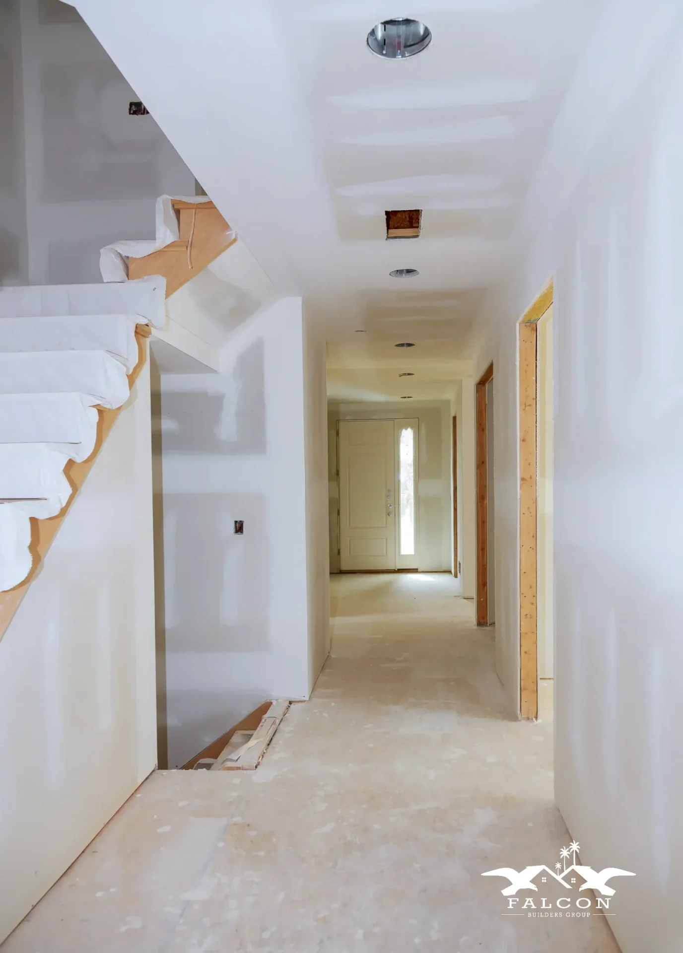 Professional interior painting service showing freshly primed white walls and ceilings in residential hallway during home renovation project.