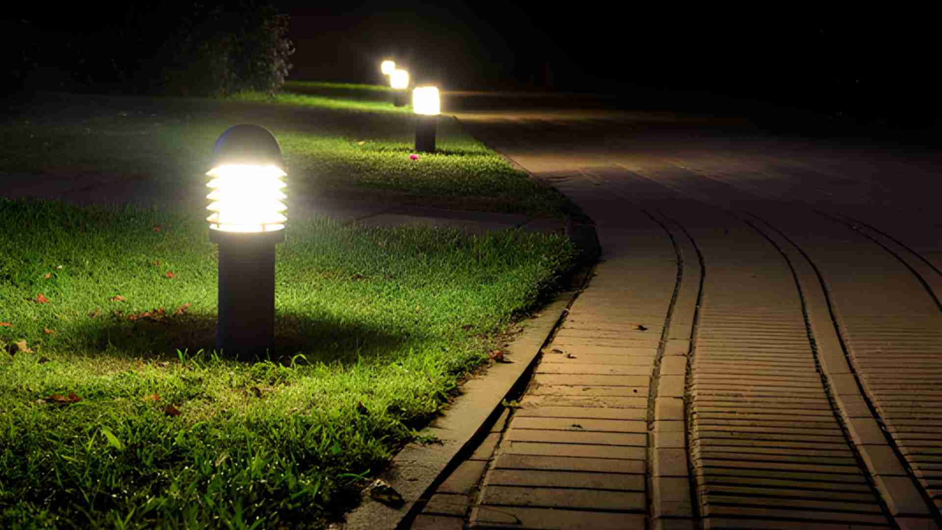Pathway illuminated by modern outdoor lighting at night for backyard safety